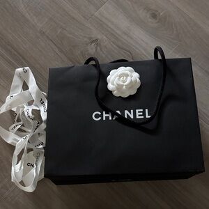 Chanel Black Bag with White Floral Detail gift bag